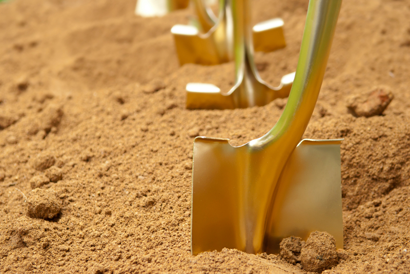 Breaking ground, ground, shovel, dirt, gold, gold shovel, grand opening, innovative.